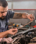 Mechanic using Copper Coated Gouging Carbon Rods Set For Auto Welding And Dent Repair 5 Piece Arc Gouging Sticks With Quick Dent Fix Feature Pro Grade Welding Gear For Car Body Repairs And Maintenance