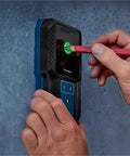 Pro Grade Auto Calibrating Stud Finder Wall Scanner in use, detecting wires and studs on drywall with green indicator.
