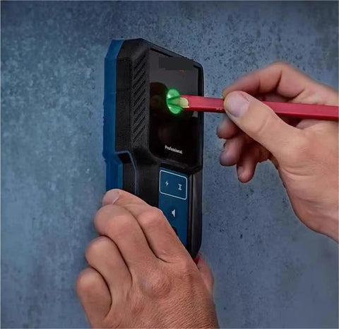 Pro Grade Auto Calibrating Stud Finder Wall Scanner in use, detecting wires and studs on drywall with green indicator.