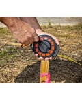 Three Eighths Inch By Fifty Foot Steel Construction Long Tape Measure with Three To One Gear in use outdoors, showing grippy handle.