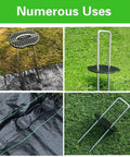 100Pcs Garden Staples Plastic Buffer Washers for landscape stakes installed on green and black weed barrier fabric.