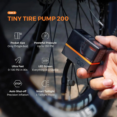 Mini Portable Bike Pump With Slick Digital Gauge And Taillight 130 PSI Electric Air Pump in use, showing LED screen and taillight.