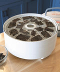 Digital Food Dehydrator With Smooth Adjustable Temperature And Even Heating For Whipping Up Homemade Beef Jerky Dried Fruit Fresh Herbs And Crispy Snacks On Four Stackable Trays In A Sleek Gray Design showing beef jerky on top tray.