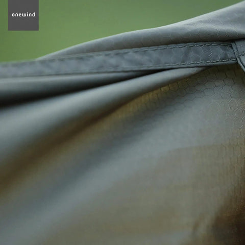 Close-up of Cozy Hammock Underquilt Protector Water Resistant Cover with 1.1 oz nylon ripstop fabric detail in OD green.