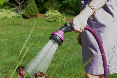 Person using One Touch Shower And Stream Garden Watering Wand With Dual Flow Modes Shower And Stream Green for plant watering.