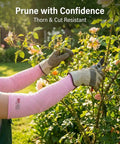 Heavy Duty Cut Resistant Arm Sleeves With Thumb Holes For Mechanics And Glass Handling Shielding Delicate Skin Straight Up Like Body Armor In Pink Pair worn while pruning roses.