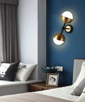 Dope Vintage Gold Globe Wall Sconce With Two Lights And Milk Glass Shades in bedroom setting, modern mid-century decor style.