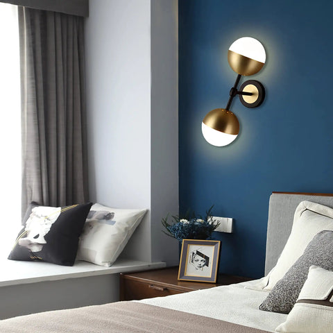 Dope Vintage Gold Globe Wall Sconce With Two Lights And Milk Glass Shades in bedroom setting, modern mid-century decor style.