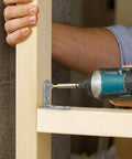 Person installing 24 Pack Heavy Duty L Brackets With Screws Rust Resistant Stainless Steel on a wood shelf.