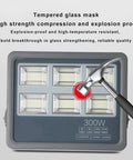 JUDYSSY 150-800W Led Flood Light Outdoor, Super Bright Led Security Light Ip66, 300W with a hammer showing impact resistance.