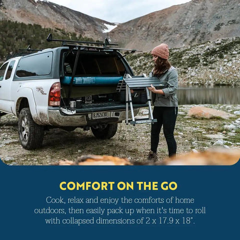 Woman with Compact Camp Table 20 near truck outdoors, showcasing foldable one-piece design for outdoor dining and travel.