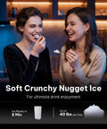 Two women enjoying soft chewable ice from the Ultimate Countertop Nugget Ice Maker Featuring Auto Drop Ice And No Sweat Self Cleaning Routine That Cranks Out 33 Pounds Of Soft Chewable Ice Daily For Totally Chill Weekend Gatherings And Quick Home Hydration.