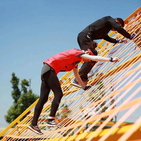 People climbing on structure made from heavy duty lifting straps for cargo handling and hauling tough as nails tear resistant polyester net sling.