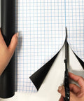 Person cutting Extra Large Chalkboard Peel And Stick Vinyl Roll Nine Feet Long With Five Color Chalk Included for DIY use