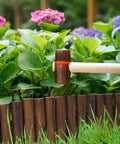 Installing Wooden Garden Edging Border With Burnt Wood Finish Flexible No Dig Landscape Border around flower bed.