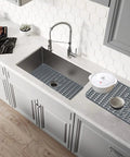 Overhead view of 29 By 15.35 Inch Silicone Kitchen Sink Mat No Fuss Heat Resistant Easy Clean Gray Protector For Stainless Steel Sinks in use.