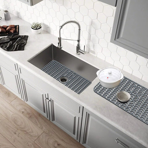 Overhead view of 29 By 15.35 Inch Silicone Kitchen Sink Mat No Fuss Heat Resistant Easy Clean Gray Protector For Stainless Steel Sinks in use.