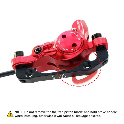 Close-up of HB875 Two-Piston Hydraulic Disc Brake Set for Mountain Bikes and E-Bikes, red aluminum caliper detail.