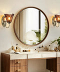 Vintage Glass Wall Sconces Set of 2,Aged Brass Bathroom Vanity Lighting above a stylish vanity with round mirror.