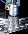 Carbide-tipped annular cutter, 21/32 in dia, installed on drill press cutting metal.