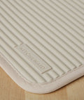 Ribbed Soft Silicone Pot Holder 2 Pack Set Hella Heat Resistant To 500F in Milkshake Tan with textured grip surface.