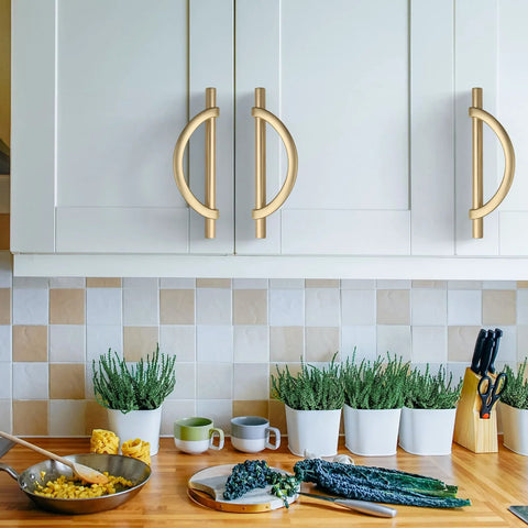 Brushed Gold Cabinet Pulls 5 Inch 128mm Hole Centers 10 Pack Handles installed on white kitchen cabinets above countertop.