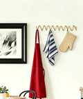 Heavy Duty Gold Wall Mounted Coat Rack With Sculpted Wavy Hooks Hanging Coats Hats Bags And Umbrellas Zero Clutter Bedroom Decor For Living Rooms And Bathrooms Top Shelf Build with red apron and kitchen towels.