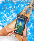 Person using touchscreen phone in Six Pack Multicolor Waterproof Phone Pouch Set With IP68 Rating at poolside