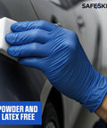 Safeskin Ultralight blue nitrile glove on hand near a car door handle, powder-free, latex-free.