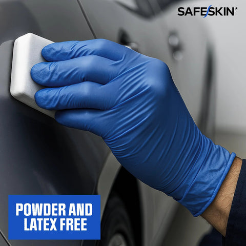 Safeskin blue nitrile disposable glove used to wipe a car panel; powder and latex free.