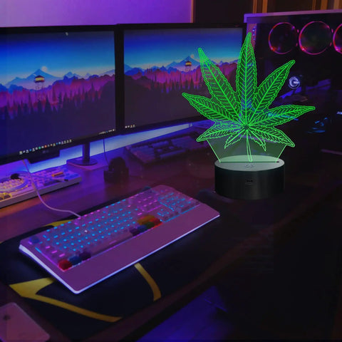 3D Illusion Night Light With Remote, 16 Color Changing LED Lamp on desk with green leaf design, ideal for modern decor