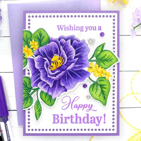 Handmade birthday card with purple flower illustration and 'Wishing you a Happy Birthday!' message on violet background.
