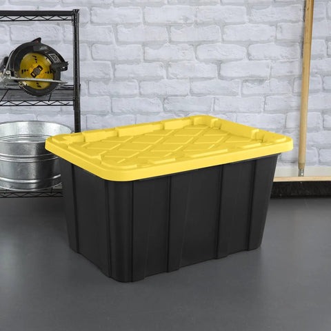 Six Pack Heavy Duty Stackable Industrial Totes Top Shelf Plastic Storage Bins With Secure Snap Lids Rock Solid Build For Garage Workshop And Warehouse Organization Black And Yellow view with yellow lid on gray floor.