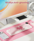 Top Shelf Wireless Mechanical Keyboard With Smart Screen And Rotary Knob, Gasket Mounted Hot Swap Tactile Switches Pre Lubed For Silky Typing, Triple Mode Bluetooth And Usb Setup, Compact 96 Percent Layout That Goes Hard For Gaming on a pink desk mat with a smartphone, mouse, and display.