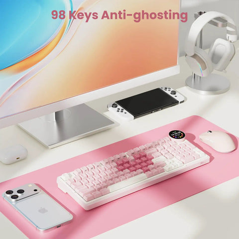 Top Shelf Wireless Mechanical Keyboard With Smart Screen And Rotary Knob, Gasket Mounted Hot Swap Tactile Switches Pre Lubed For Silky Typing, Triple Mode Bluetooth And Usb Setup, Compact 96 Percent Layout That Goes Hard For Gaming on a pink desk mat with a smartphone, mouse, and display.