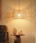 Handcrafted Boho Plug In Pendant Light With Artisan Woven Shade, Easy Three Way Switch, Extended Cord For Serious Chill Living Room Aura And Definitely Solid Decor Flex Year Round hanging above a wooden table.