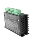 TB6600 stepper motor driver module with green terminal block, black heatsink housing, side view.