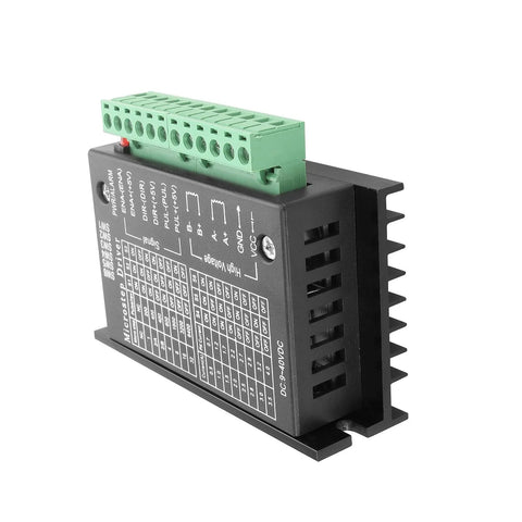 TB6600 stepper motor driver module with green terminal block, black heatsink housing, side view.