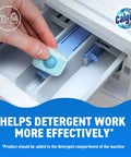 Straight Up Heavy Duty Washing Machine Cleaner And Water Softener Tablets in hand above detergent compartment.