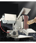 Compact Mini Electric Belt Sander Perfect For Desktop DIY Projects in use, sanding a wooden piece with metal components.