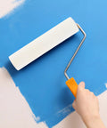 Person using a High Density Polyurethane Paint Roller on a wall for smooth finishes.