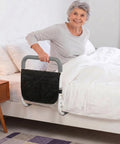 Woman using Heavy Duty Bed Rail For Seniors With Non Slip Foam Grip And Safety Strap ASTM Certified Bedside Guardrail Tool Free Install.