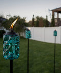 Topaz Blue Glass Outdoor Torches Two Pack, 65 Inch Weather Resistant Patio Lanterns for backyard and garden, with fiberglass wick.