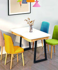 Dining table with 36 Inch Metal Table Bar Legs Heavy Duty Beefy Industrial Style, surrounded by colorful chairs.