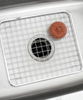 Stainless Steel Sink Grid Protector Kitchen And Bath Rugged Dish Rack in a sink with a scrub pad on top, 12.75x11 inches.