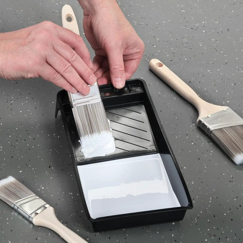 Hands using 4 Inch Paint Tray Pan Set 12 Pack Black Spill Resistant Mini Trays With Dual Wells For Rollers And Roller Pan Disposable DIY Home Improvement Project Supplies