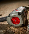 1 Inch Air Impact Wrench With D Handle 2100 Ft Lbs Max Torque Heavy Duty Pneumatic Tool on the ground in a service bay