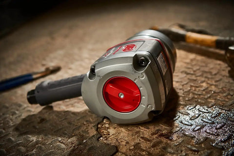 1 Inch Air Impact Wrench With D Handle 2100 Ft Lbs Max Torque Heavy Duty Pneumatic Tool on the ground in a service bay