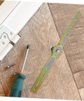 Side view of QUMIIRITY adjustable angle furniture hinge with gear wheel and mounting strap; screwdriver and screws nearby.