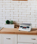 Electronic platform scale placed on a kitchen countertop with 4 Pack Replacement Scale Feet For Electronic Platform Scales With Shock Absorber Design.